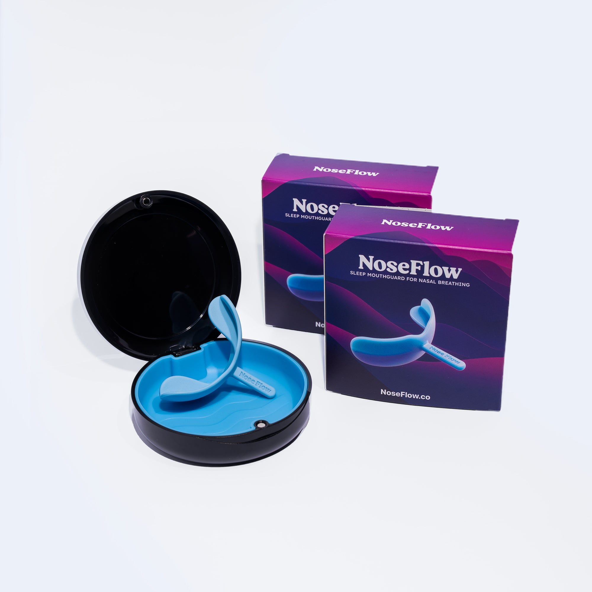 Blue NoseFlow sleep mouthguard inside open black storage case for easy use and travel.